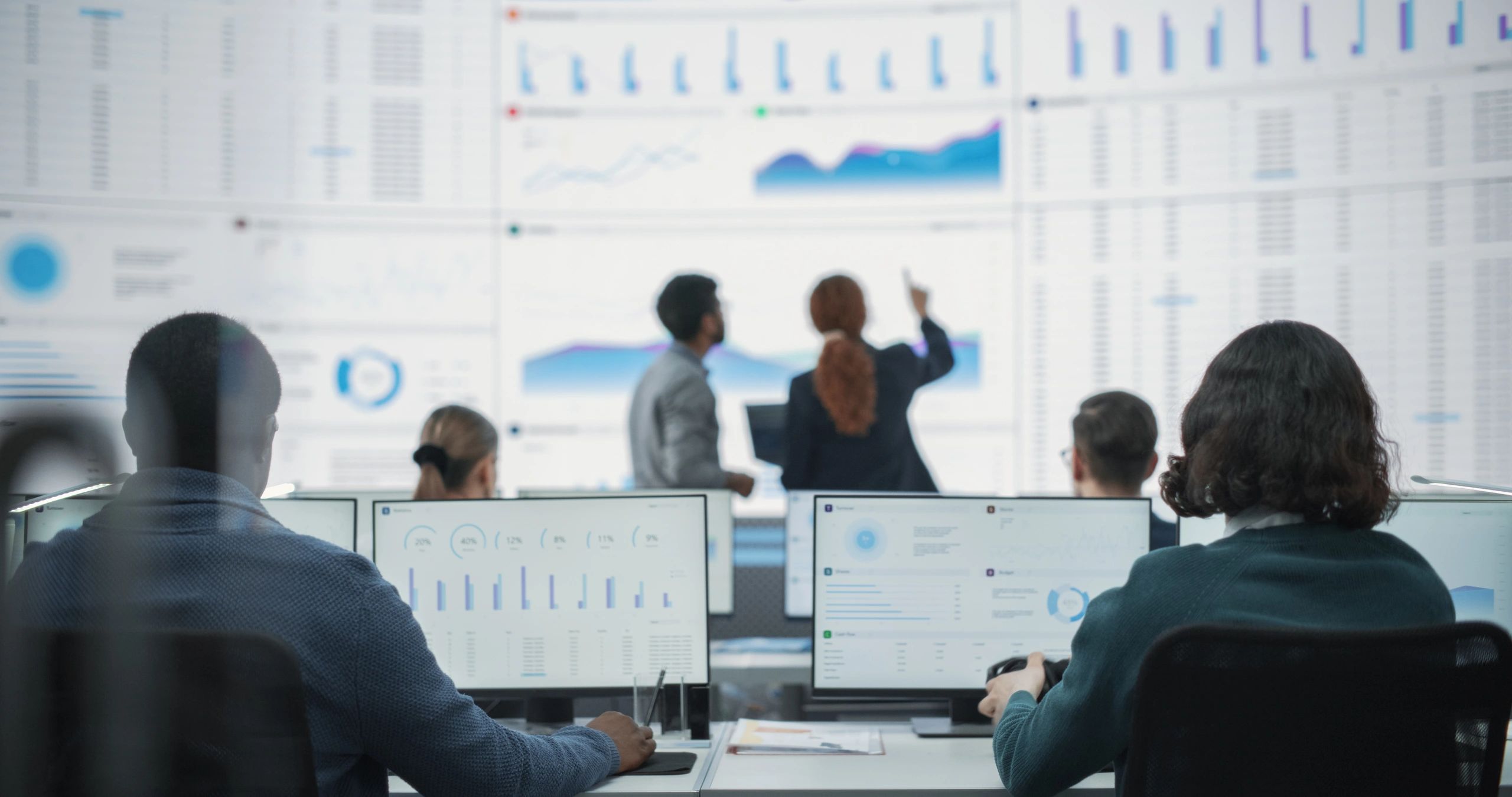 Risk managers analyzing data in a monitoring room