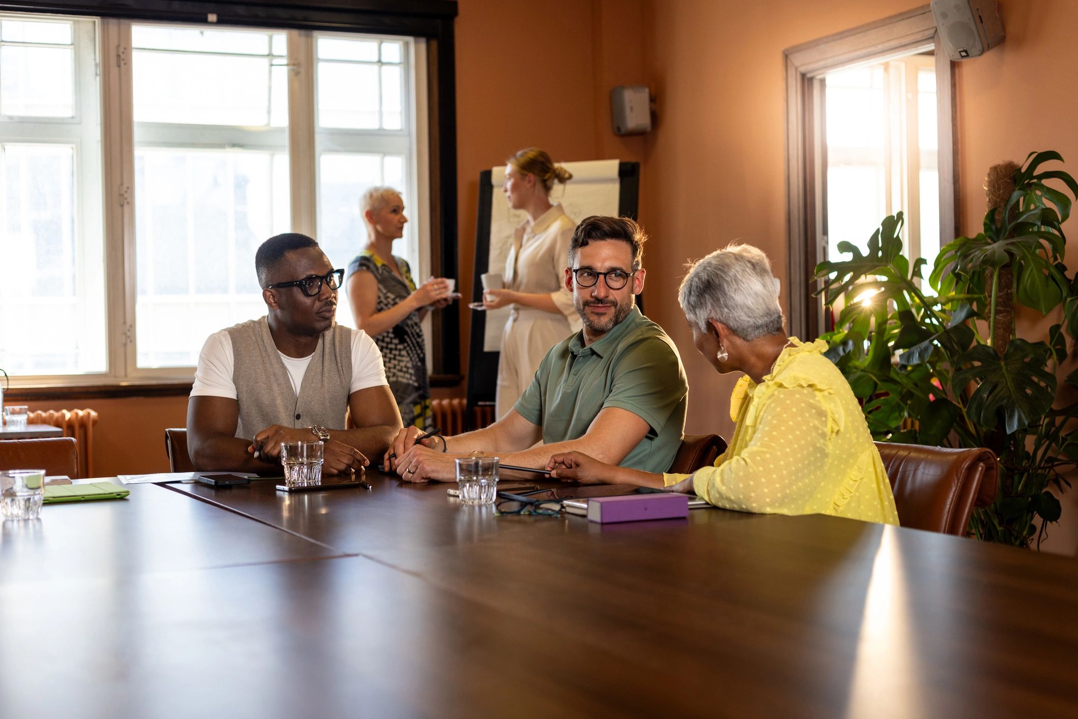 Business professionals collaborating on technology strategy in a modern office